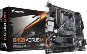 Imagem mostrando a Placa Mãe Gigabyte B450 Aorus M. É possível ver a caixa da placa a esquerda, e a placa inteira, em pé, a direita. A placa é robusta, da cor preto fosco com detalhes prata. A caixa é de cor preta, com uma imagem de águia prateada estilizada, a palavra "Aorus" escrita em letras brancas na parte superior, e "B450 Aorus M" escrito em letras laranjas e brancas na parte inferior, letras maiores. O fundo é branco.