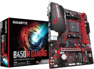 Imagem da Placa Mãe Gigabyte B450. É possível ver a placa mãe, em primeiro plano, na parte direta da imagem, e caixa da placa, em segundo plano, na parte esquerda da imagem. A placa é preta, com detalhes em vermelho e prata. A caixa é da mesma cor, "gigabyte" escrito em letras brancas na parte de cima e "B450M Gaming", primeira palavra em letras brancas e as demais em vermelho, na parte inferior.
